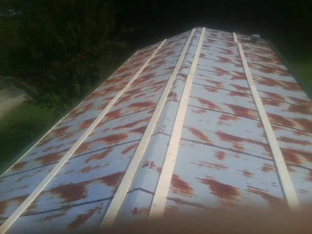 Rusted metal roof panels with new wood purlins before replacement — Storm Damage Roof Repair in Cave City by Roofing Brothers