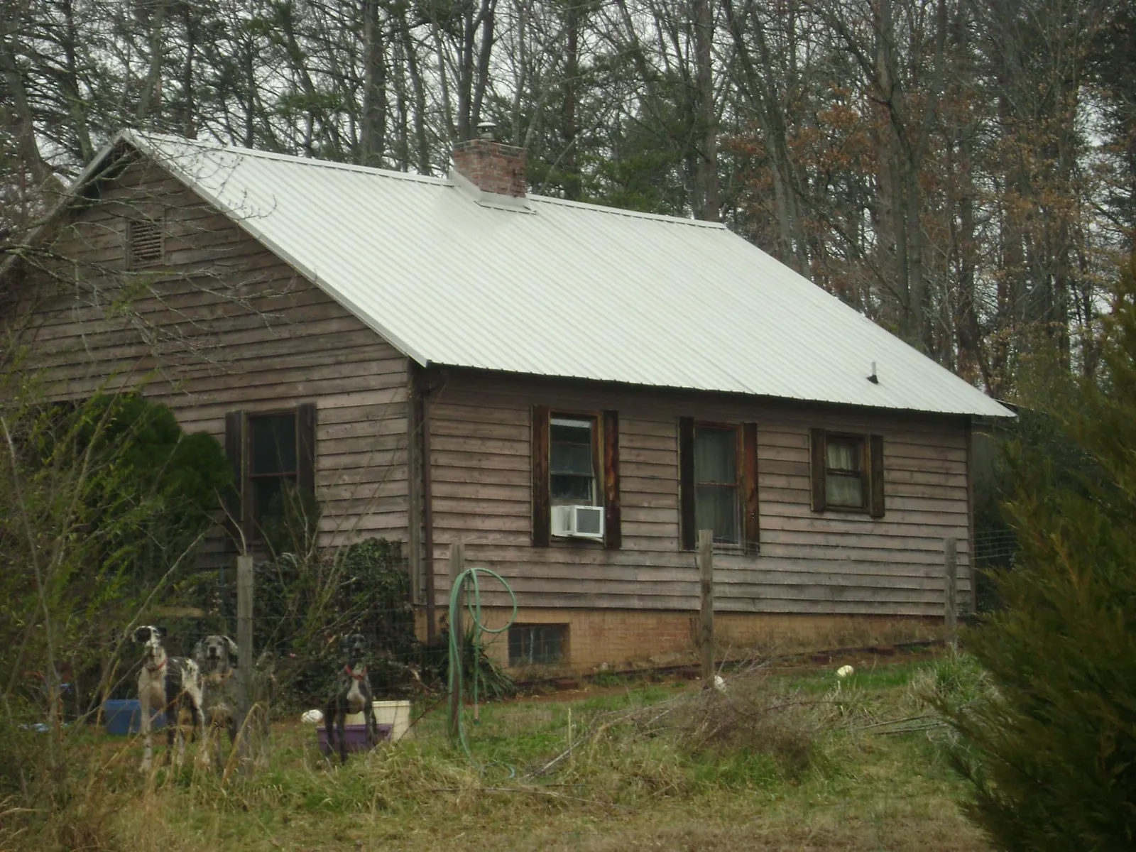 White metal roof on an old wood sided farmhouse, from a Metal Roof Installation job in Cave City